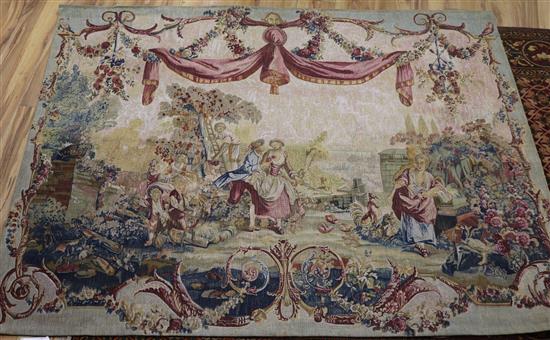 After Boucher, a tapestry wall hanging worked with figures beneath drapery swags 4ft 10in. x 5ft 11in.